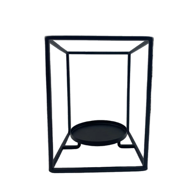 Black metal candle holder with a round base on a white background